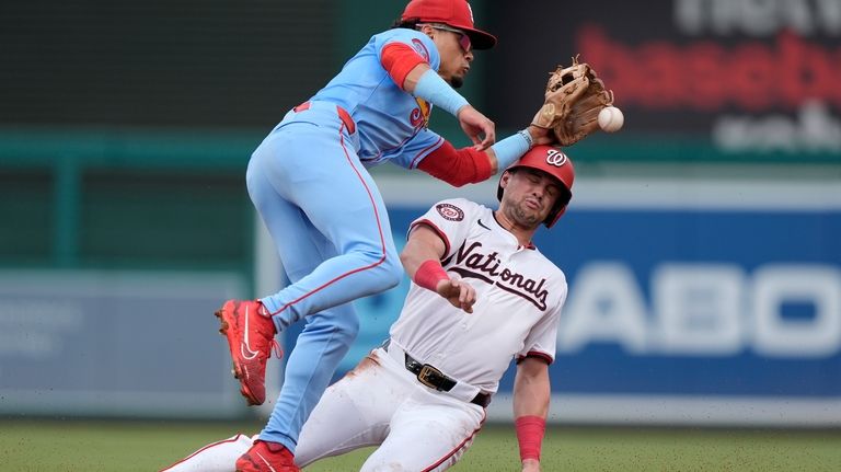 Washington Nationals' Lane Thomas, right, collides with St. Louis Cardinals...