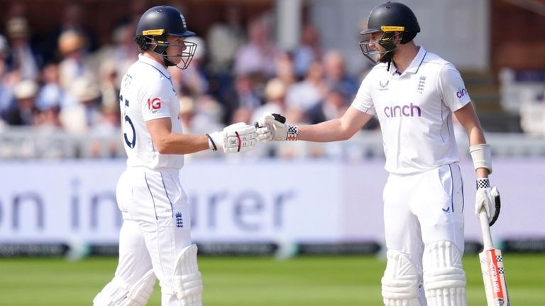 England's Gus Atkinson, right, and Matthew Potts prepare to bat...