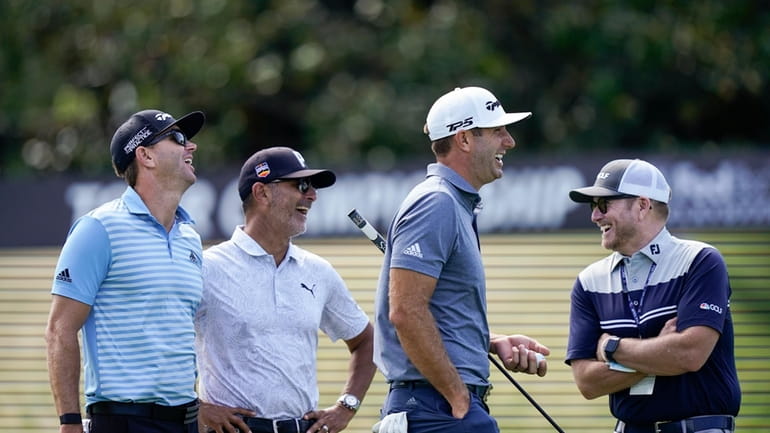 NBC on-course reporter John Wood, right, Dustin Johnson, second from...
