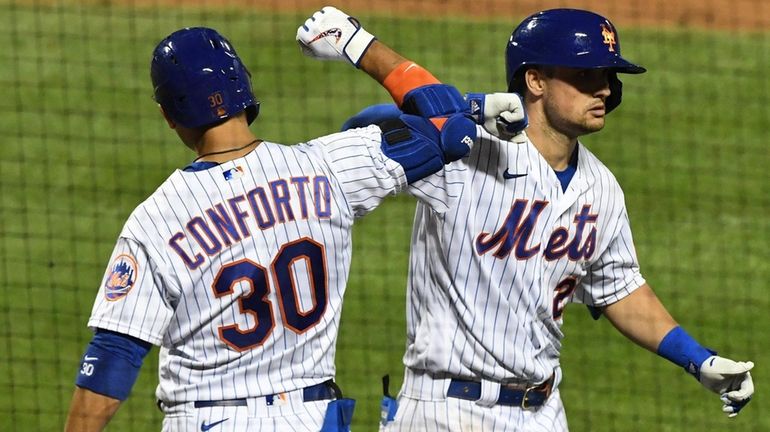 The Mets' J.D. Davis celebrates his three-run home run with...