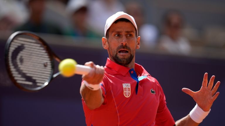 Serbia's Novak Djokovic returns the ball to Spain's Carlos Alcaraz...