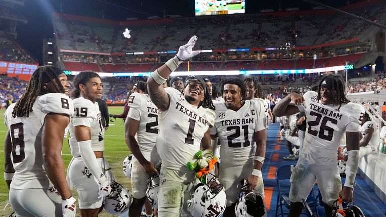 Texas A&M players celebrate as time expires on the clock...