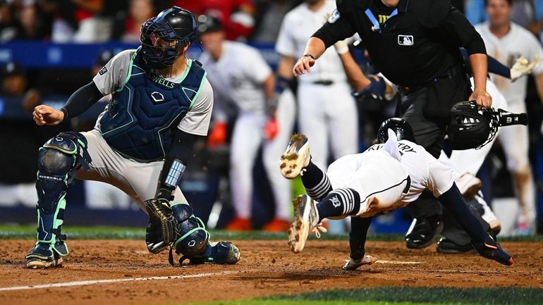 Zach McKinstry #39 of the Detroit Tigers scores in front...