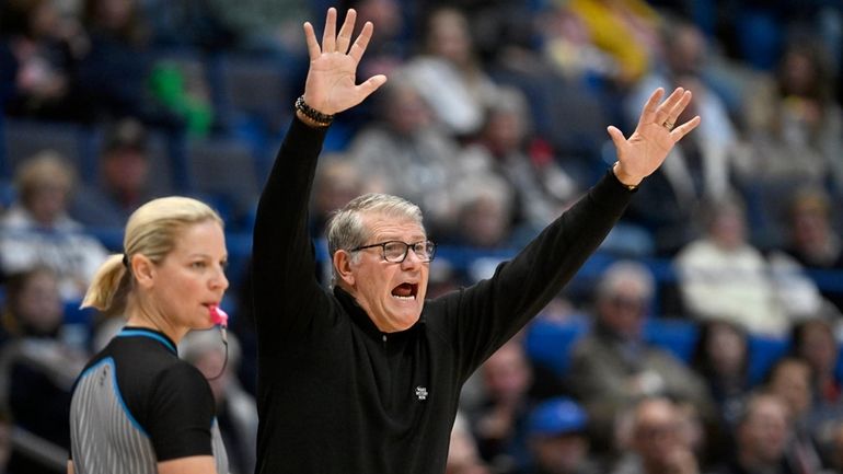 UConn head coach Geno Auriemma gestures to his team in...