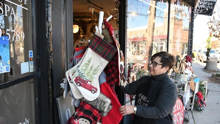 Store clerk Audrey Schneider working at the Hamptons West Vintage Boutique...