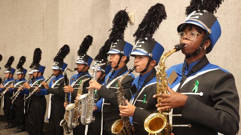 Copiague marching band members wear green ribbons, in honor of...