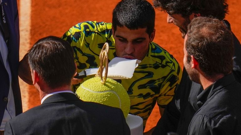 Carlos Alcaraz, of Spain, eats a pice a cake for...