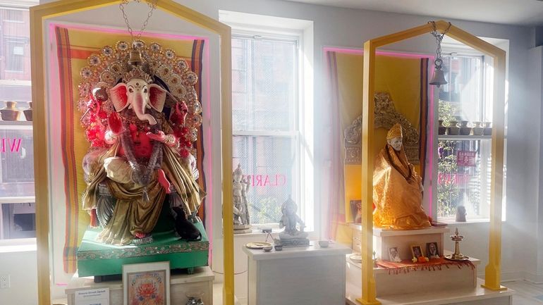 Statues of Lord Ganesha, left, and Shirdi Sai Baba are...