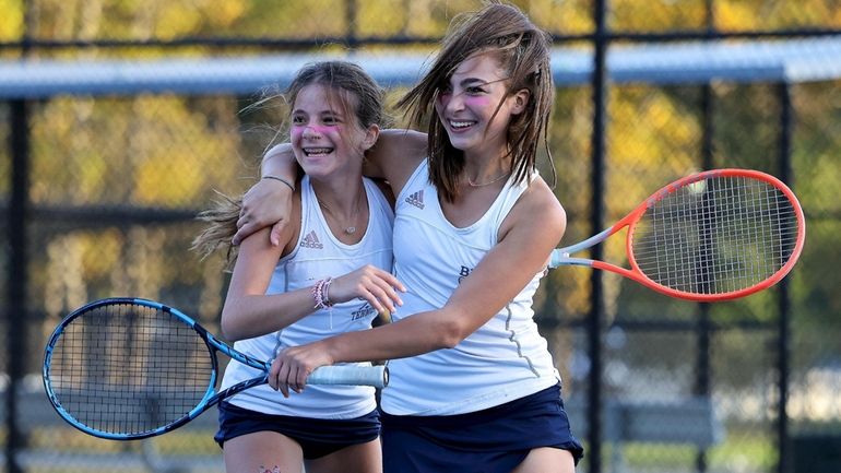 Bayport-Blue Point's Evie Romano (left) and Lily Castka react after...