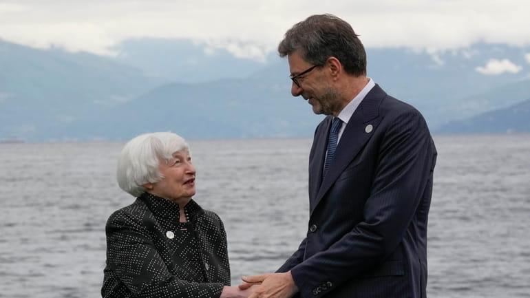 United States' Treasury Secretary Janet Yellen shakes hands with Italian...