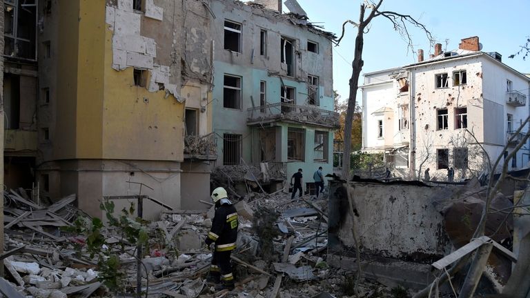 Rescuers search for victims in an apartment building destroyed by...