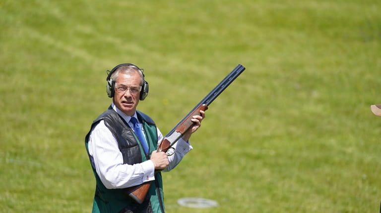 Reform UK leader Nigel Farage takes part in clay pigeon...