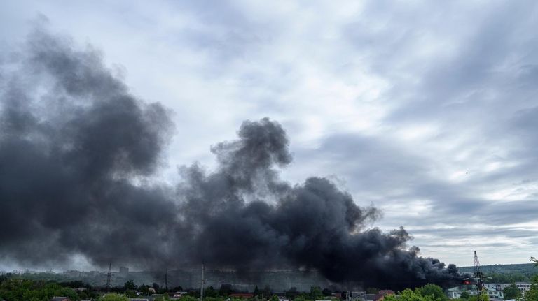 Smoke rises after a Russian attack in Kharkiv, Ukraine, Friday,...