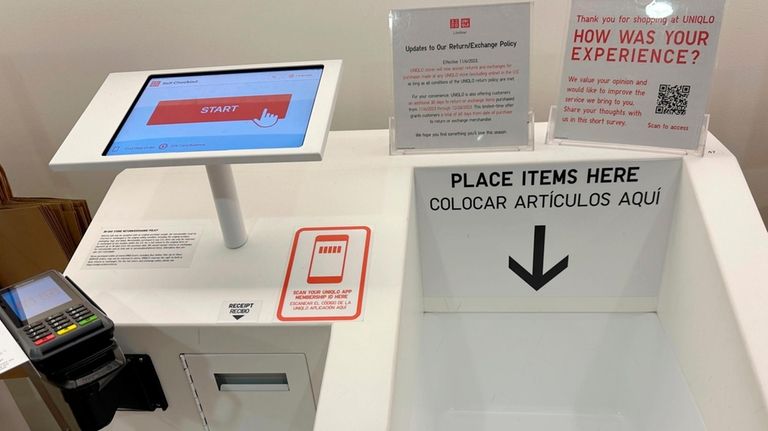 A self-checkout station is shown at a Uniqlo store in...