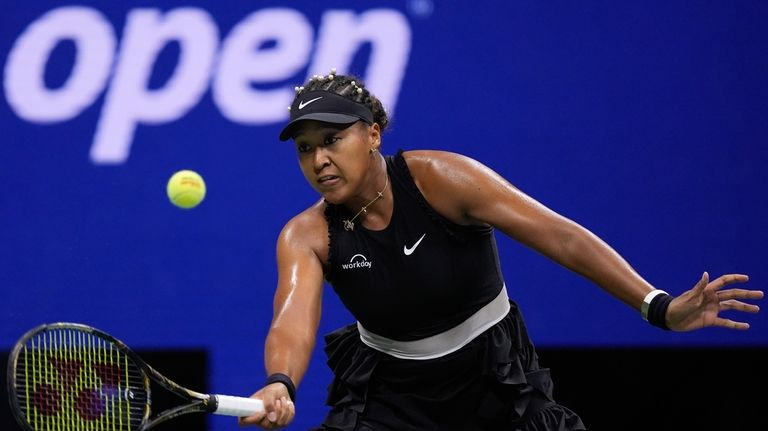 Naomi Osaka, of Japan, returns a shot to Karolina Muchova,...