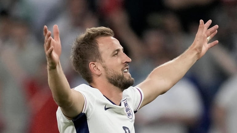 England's Harry Kane celebrates with the fans at the end...
