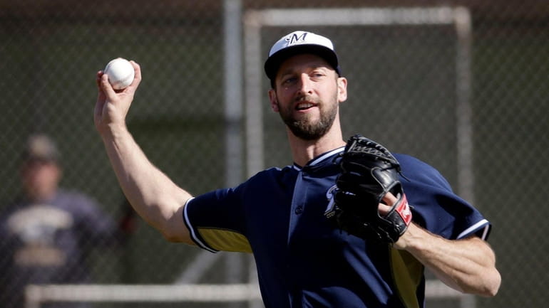 Jim Henderson throws during a spring training baseball workout Tuesday,...