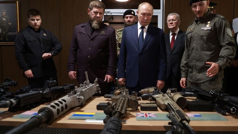 Russian President Vladimir Putin, accompanied by head of the Chechen...