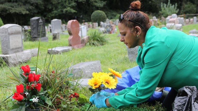 Maureen Gangaram, of Brooklyn, tends to the plot of her...