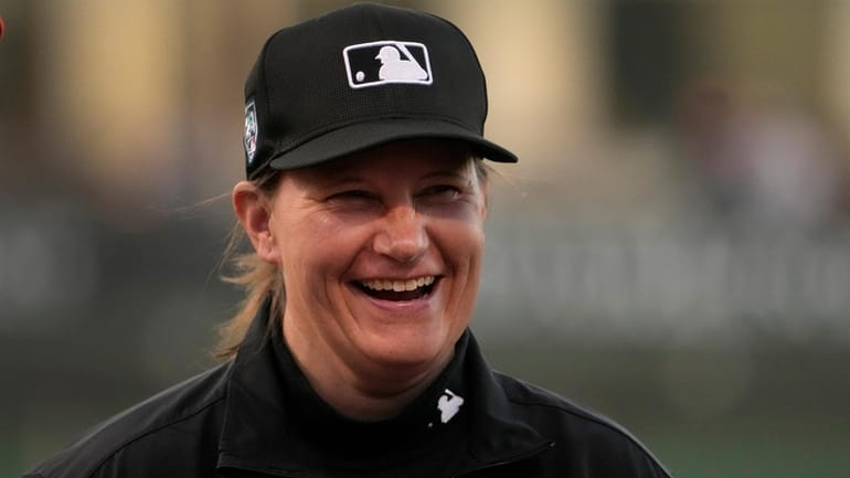 Umpire Jen Pawol smiles as she takes part in the...