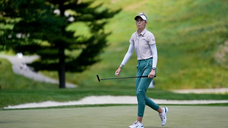 Nelly Korda reacts after making a putt on the third...