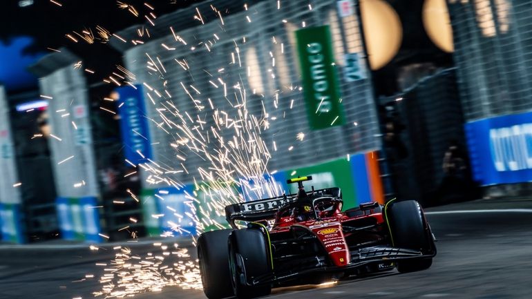 Ferrari driver Carlos Sainz of Spain steers his car during...