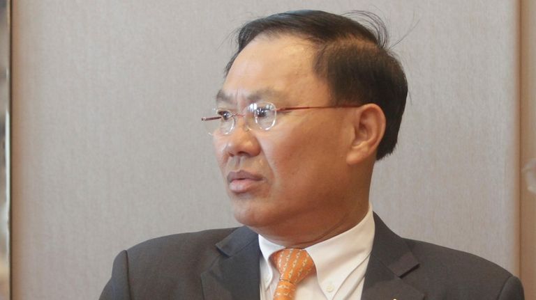 Cambodian business tycoon Ly Yong Phat stands at the Cambodia-China...