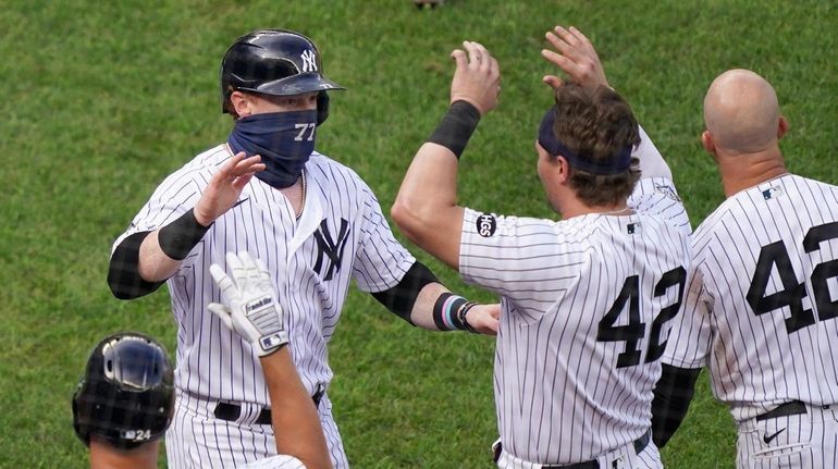 The Yankees' Clint Frazier celebrates with teammates after scoring the game-winning...