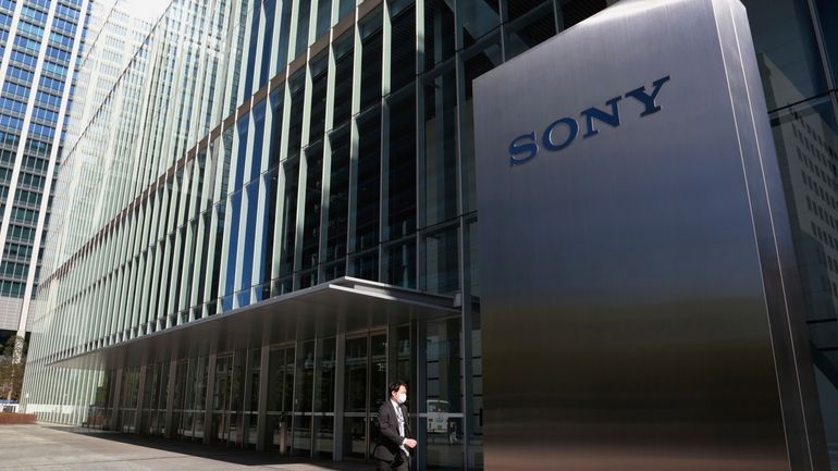 A man walks past the headquarters of Sony Corp. in...