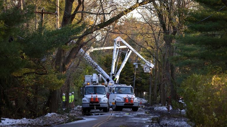 National Grid linemen work on replacing poles along Brookville Road...