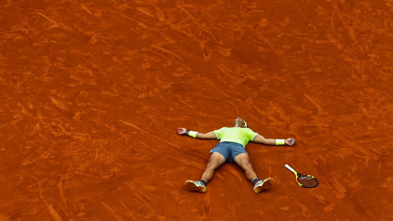 Spain's Rafael Nadal celebrates his record 12th French Open tennis...