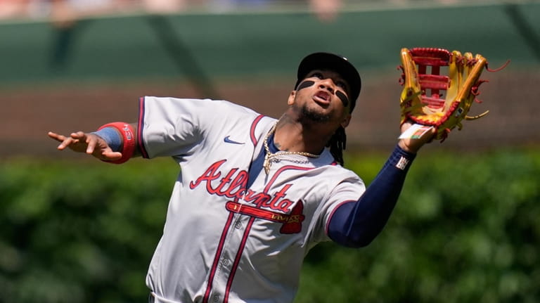 Atlanta Braves right fielder Ronald Acuña Jr. catches a fly...