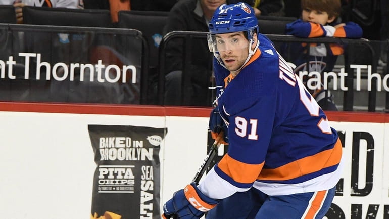 Islanders center John Tavares skates with the puck against the...