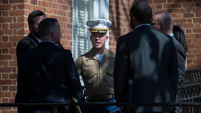 U.S. Marine Corp Major Joshua Mast, center, talks with his...