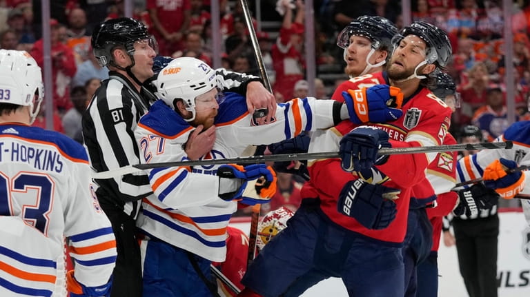 Edmonton Oilers defenseman Brett Kulak (27) throws a punch at...