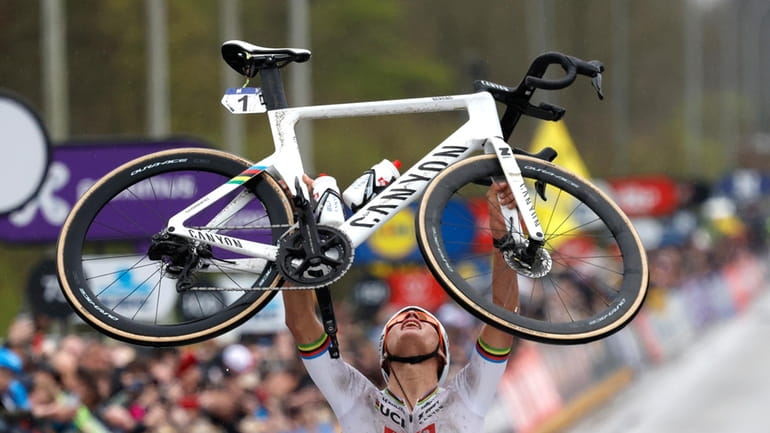 Netherland's Mathieu van der Poel holds his bike up at...