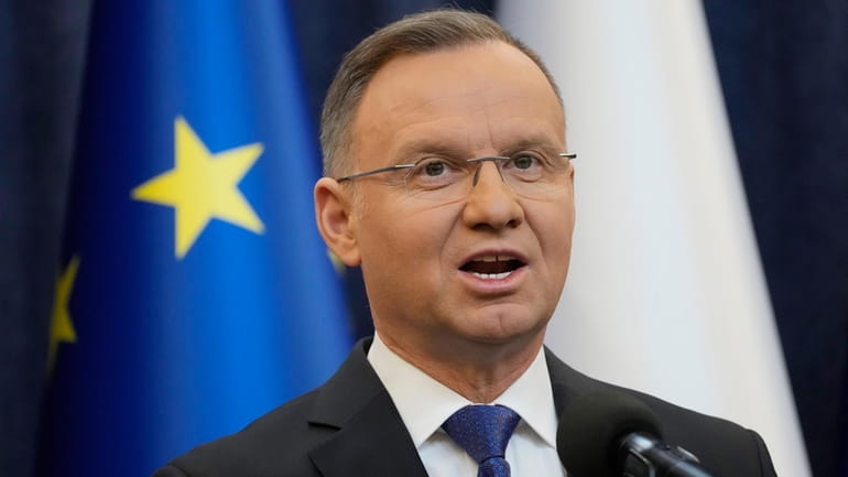 Poland's President Andrzej Duda gives a statement to the media...
