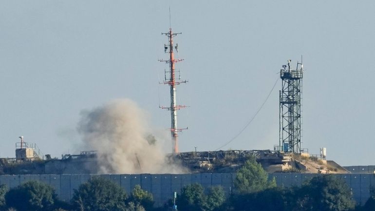 Smoke rises from inside an Israeli army position which was...