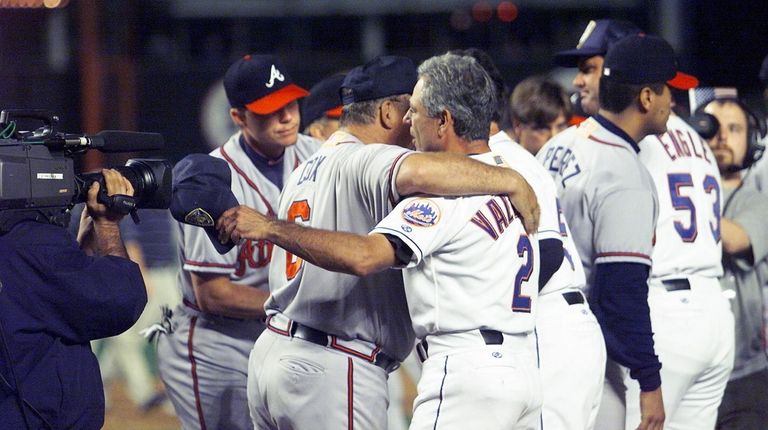 Mets manager Bobby Valentine and Braves manager Bobby Cox embrace...