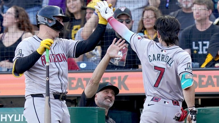 Arizona Diamondbacks' Corbin Carroll, right, is greeted by Joc Pederson,...