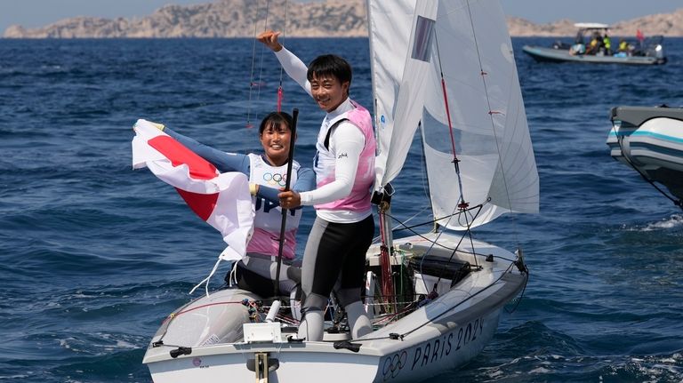 Keiju Okada and Miho Yoshioka of Japan celebrate after the...