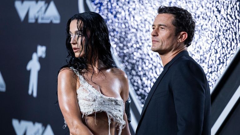 Katy Perry and husband Orlando Bloom walk the red carpet...