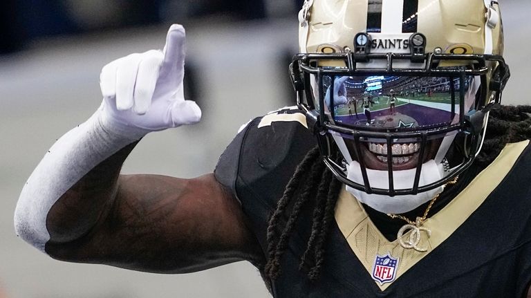 New Orleans Saints running back Alvin Kamara reacts after scoring...