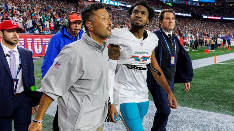 Miami Dolphins wide receiver Jaylen Waddle (17) walk out the...