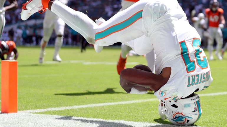 Raheem Mostert of the Miami Dolphins dives into the the...