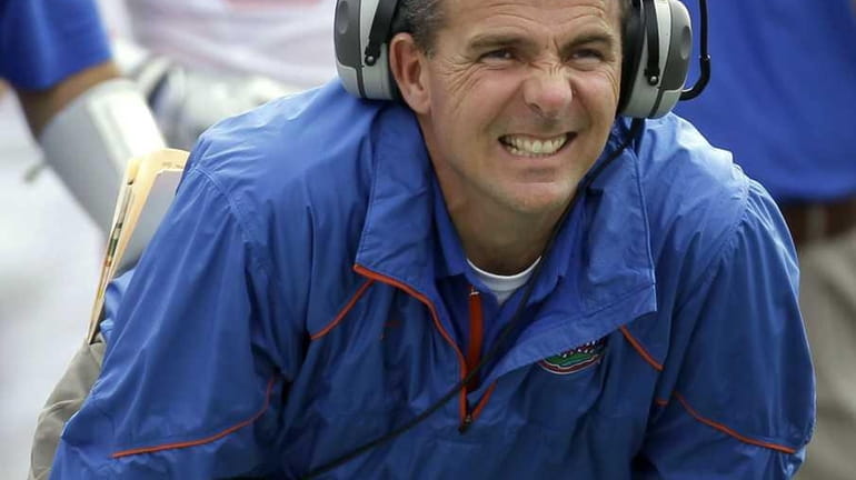 Florida head coach Urban Meyer reacts as quarterback Trey Burton...