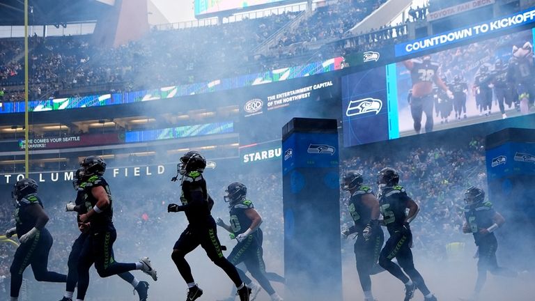 Seattle Seahawks players run on to the field before a...