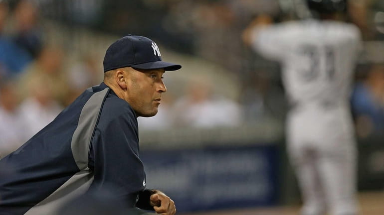 Derek Jeter, placed on the disabled list Monday, watches from...