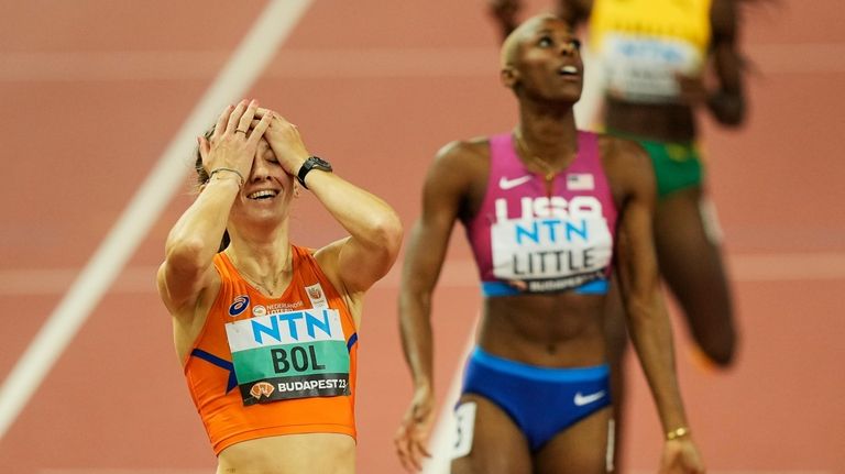 Winner Femke Bol, of the Netherlands, left, celebrates after the...