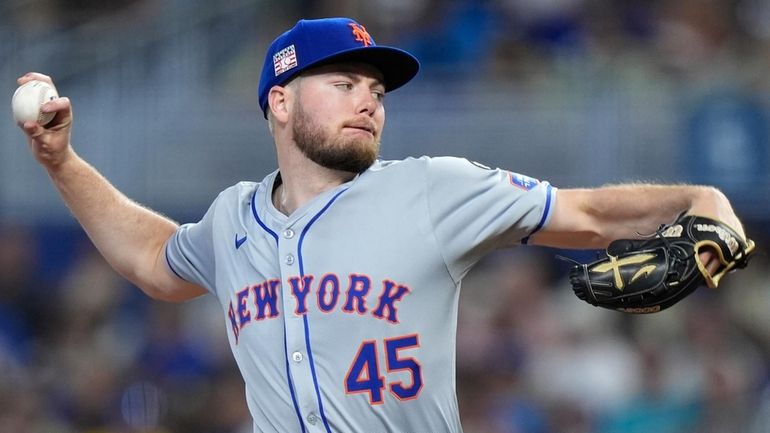 The Mets' Christian Scott delivers a pitch during the first inning...